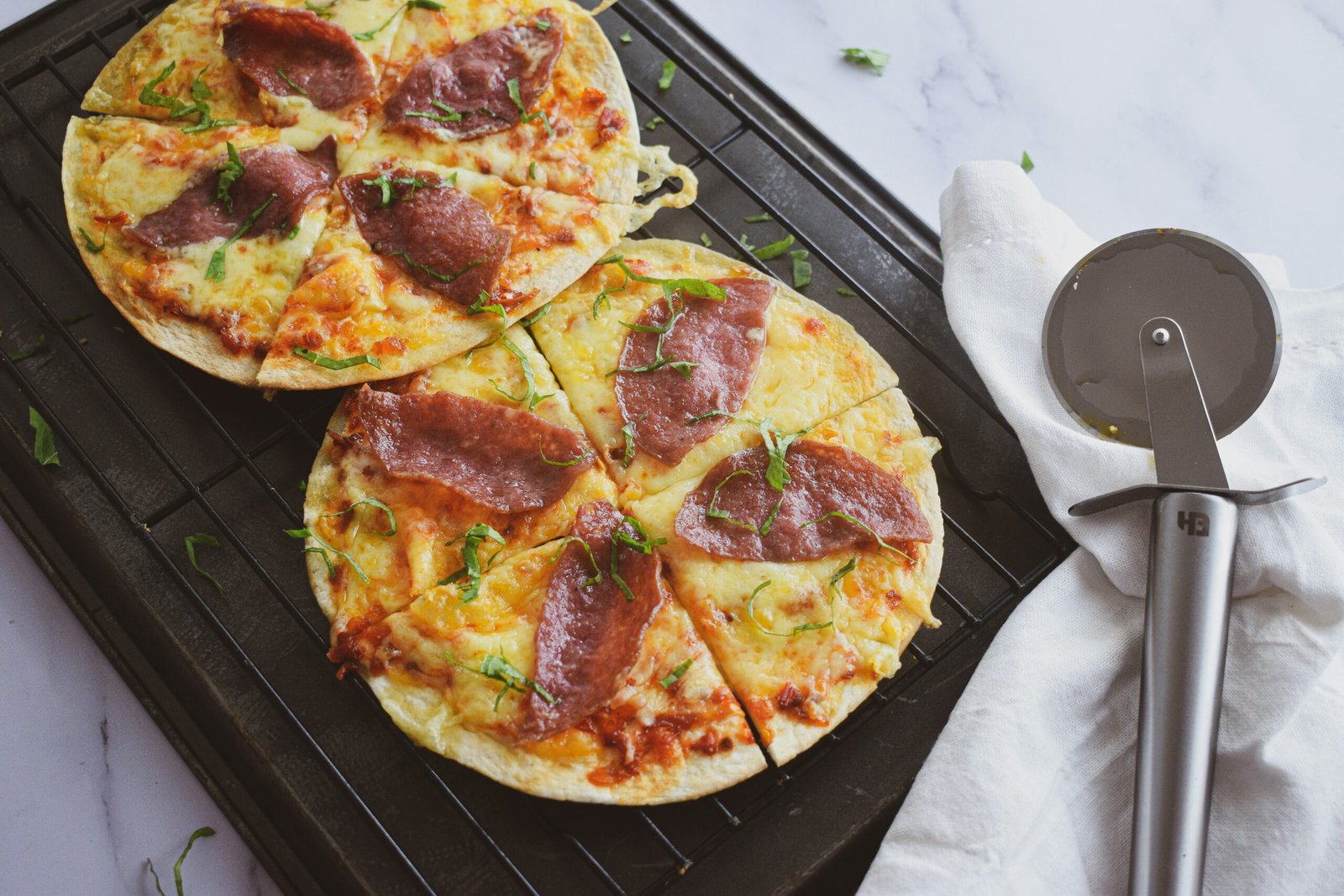 a couple of pizzas sitting on top of a pan